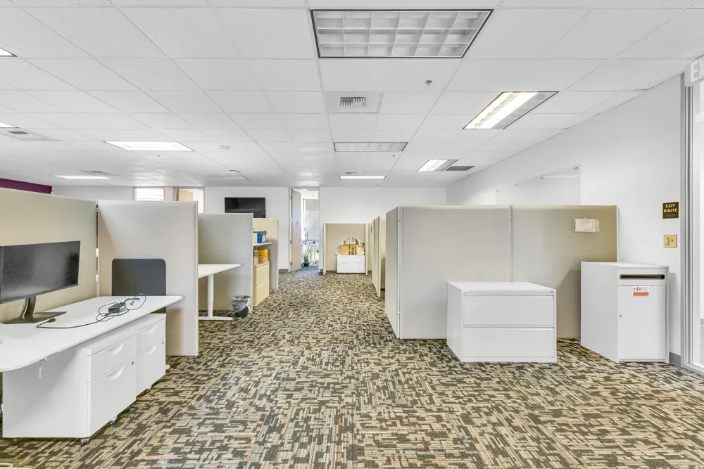 a large white kitchen with a stove a sink dishwasher and a fireplace