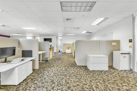 a large white kitchen with a stove a sink dishwasher and a fireplace