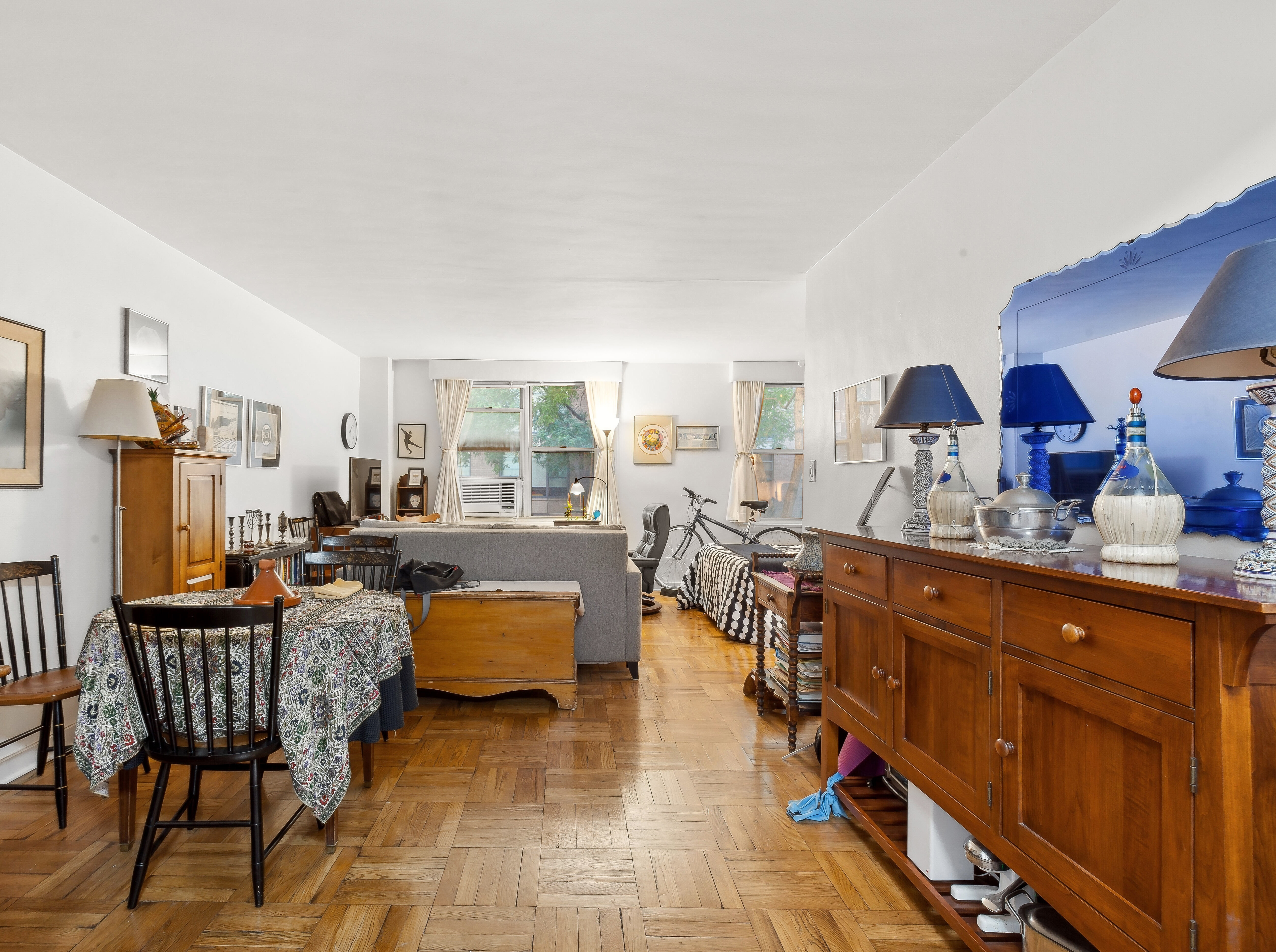 13 West 13th Street, Unit 2DS Manhattan, NY 10011 - Photo 2 of 19 a living room with furniture a lamp and large window