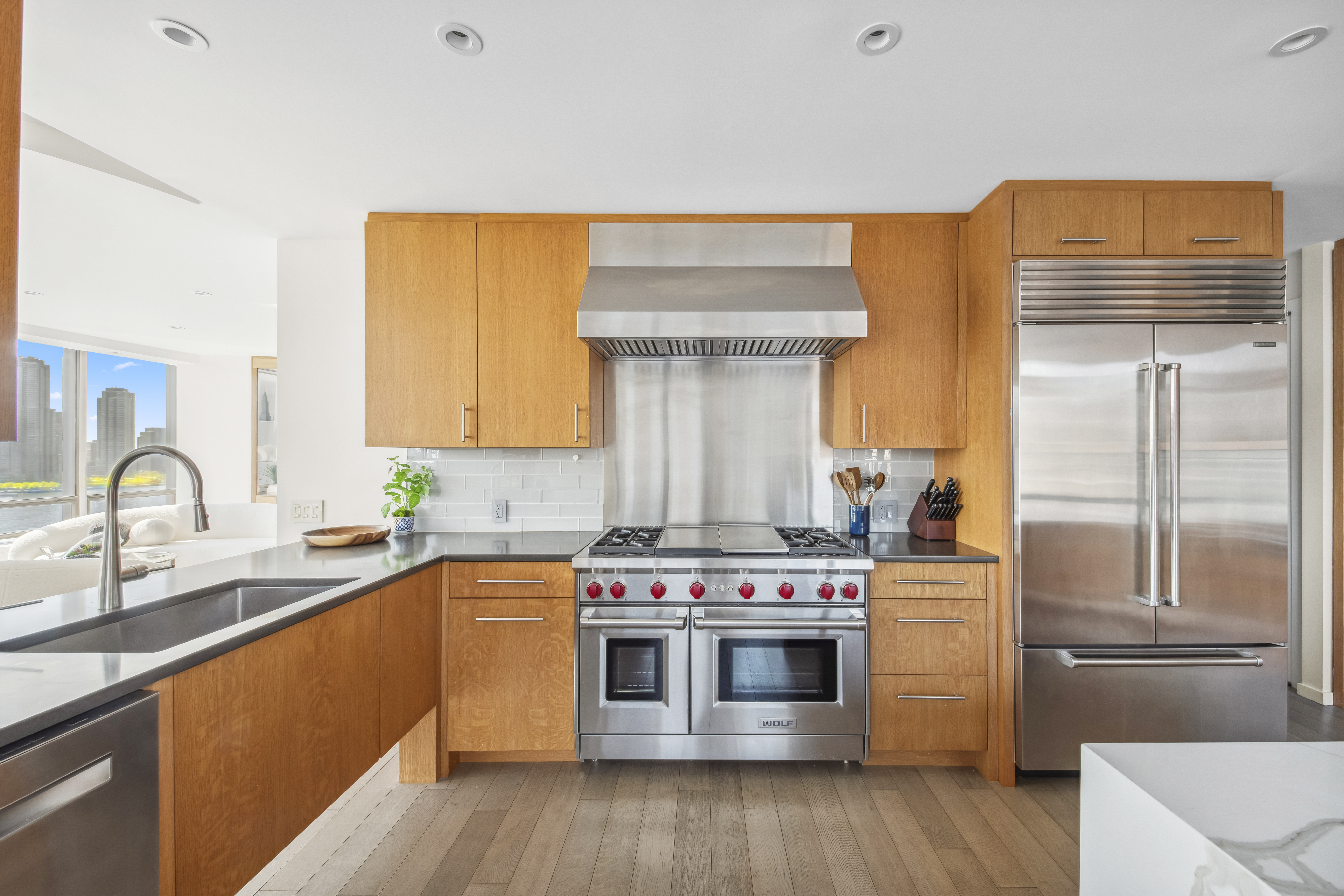 870 United Nations Plaza, Unit 15E Manhattan, NY 10017 - Photo 14 of 19 a kitchen with a stove top oven sink and refrigerator