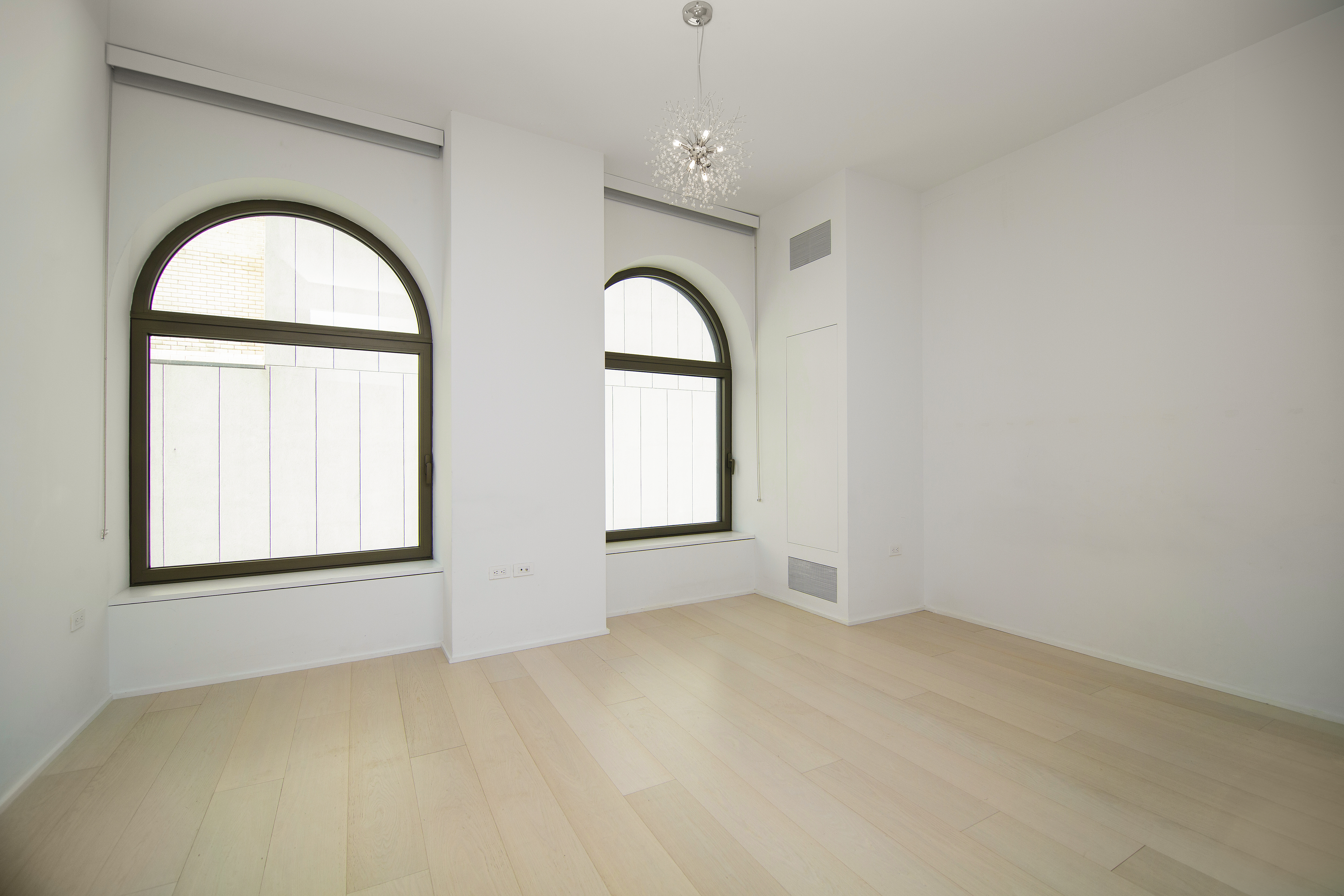 130 William Street, Unit 9E Manhattan, NY 10038 - Photo 3 of 16 an empty room with windows and mirror