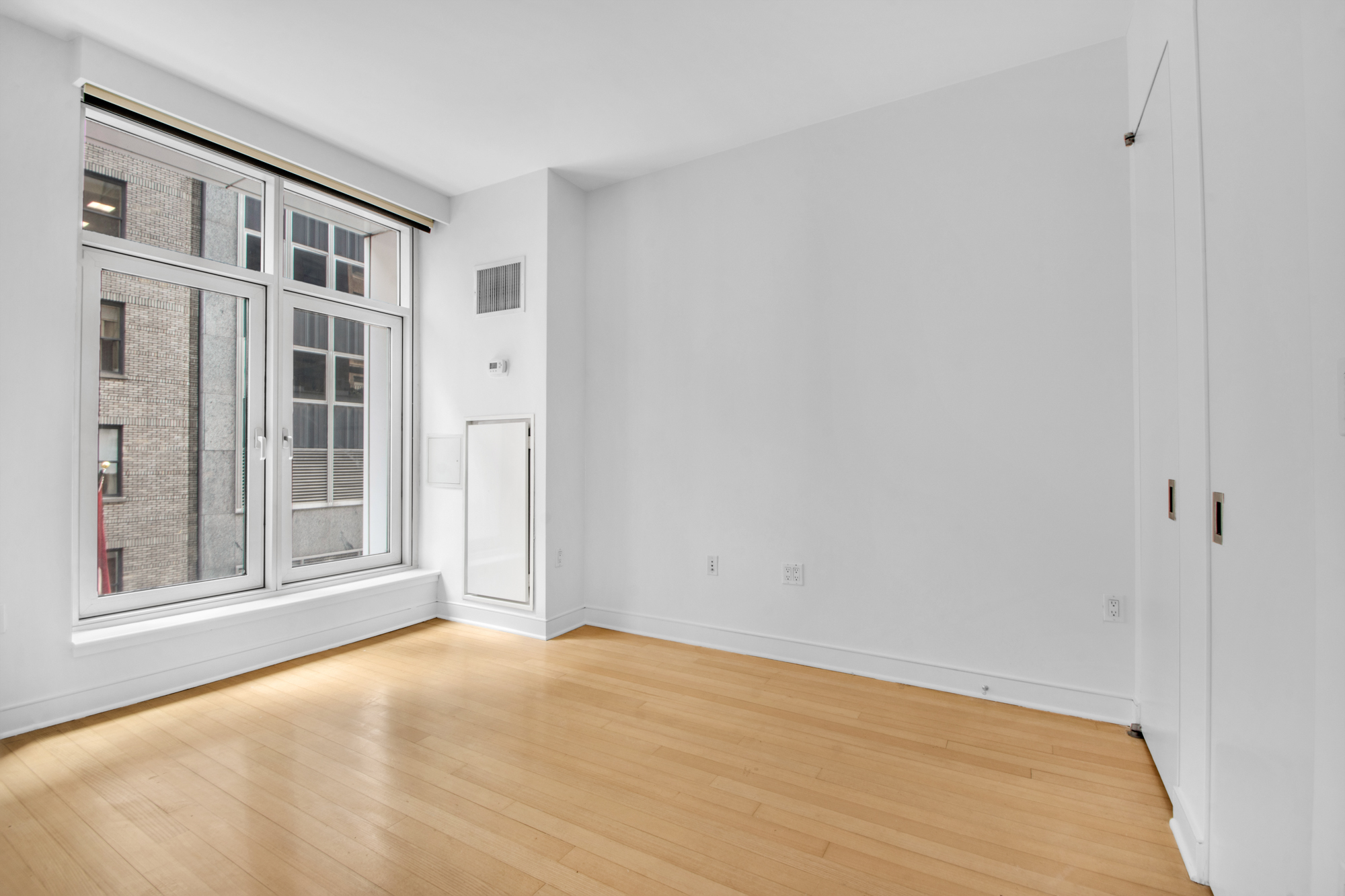 5 East 44th Street, Unit 5A Manhattan, NY 10017 - Photo 4 of 15 a view of an empty room with a window