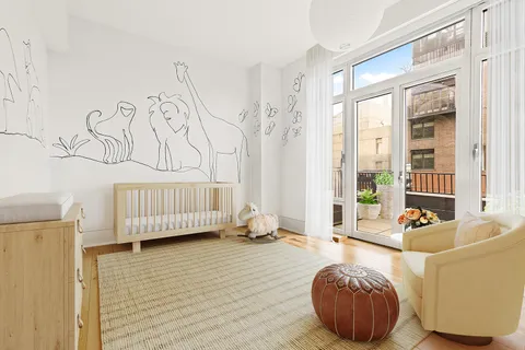 a bedroom with furniture and a large window