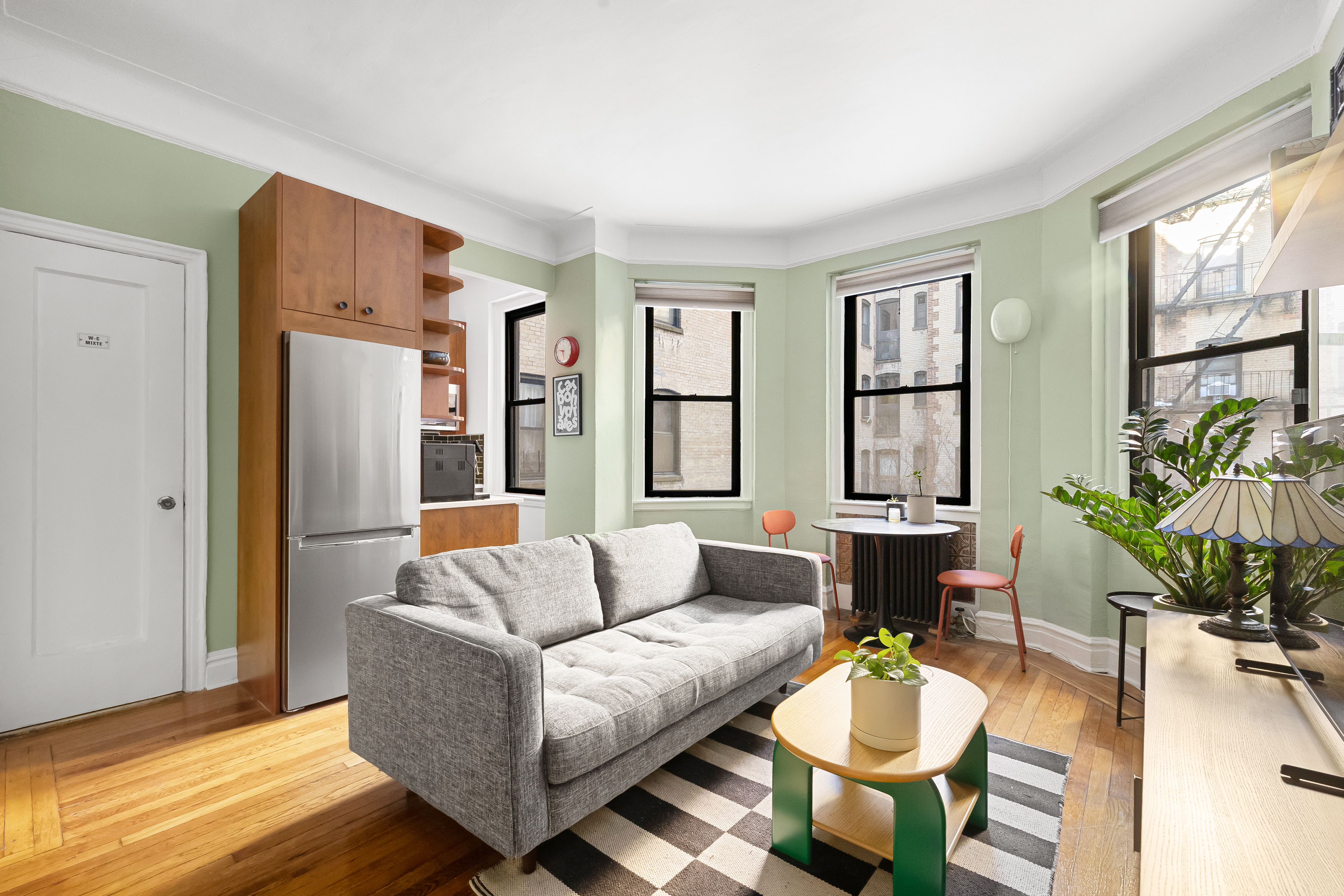 78 8th Avenue, Unit 2K Brooklyn, NY 11215 - Photo 2 of 10 a living room with furniture and a large window