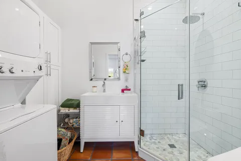 a bathroom with a sink toilet and shower