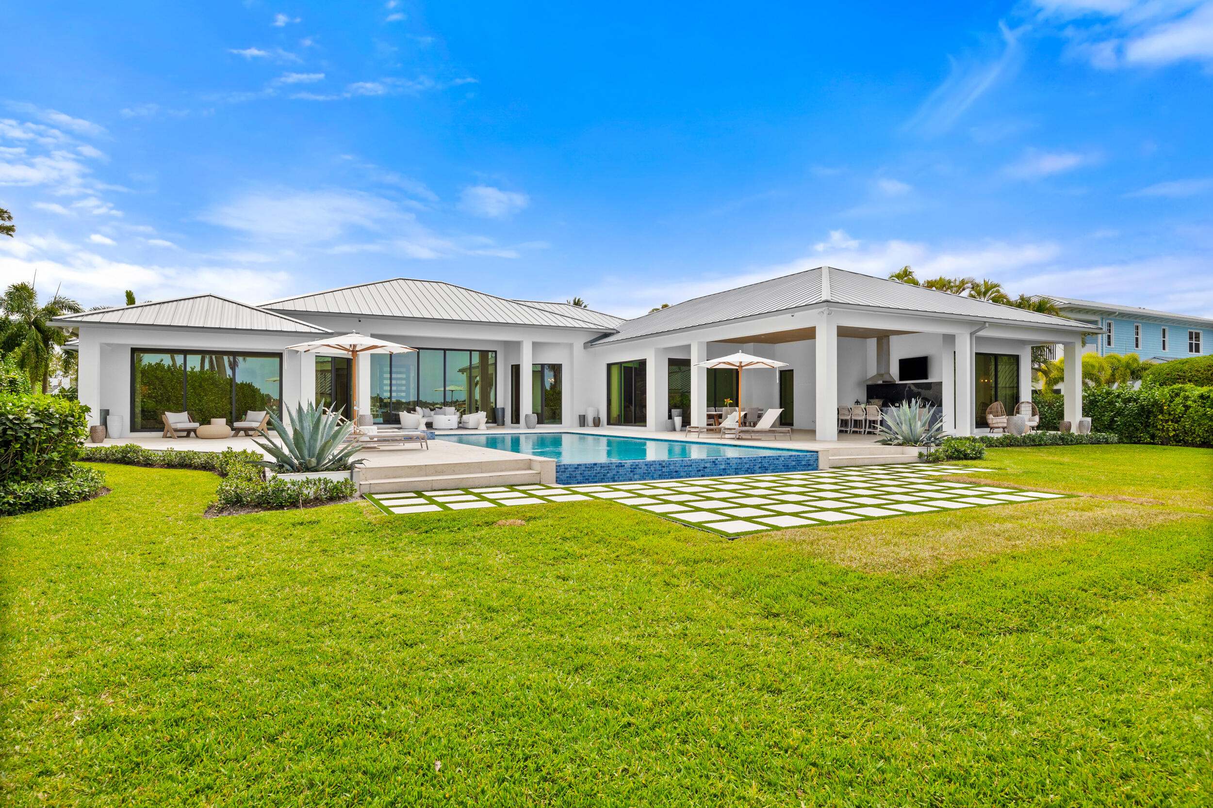 5695 Pennock Point Road Jupiter, FL 33458 - Photo 9 of 77 a front view of a house with swimming pool having outdoor seating