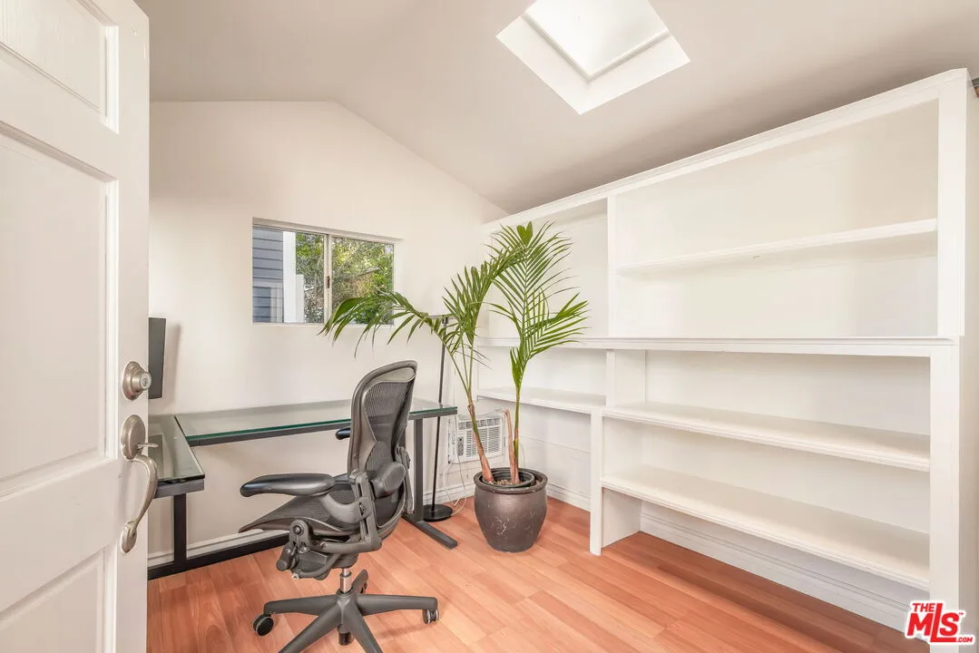 a view of a workspace with furniture and a potted plant