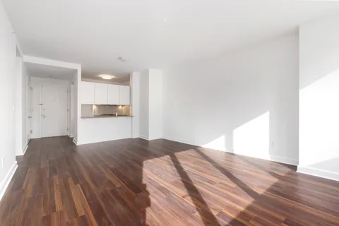 a view of kitchen and hall with wooden floor