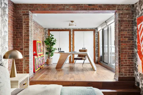 an entryway with wooden floor and windows