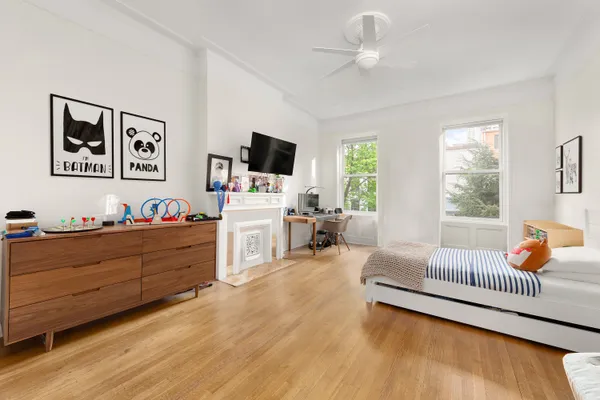a bed room with furniture and a flat screen tv