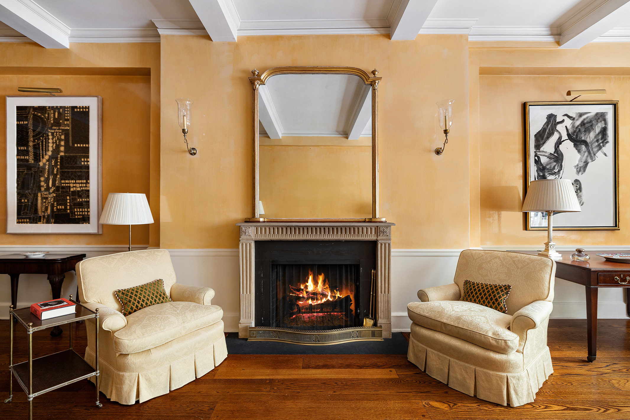 116 East 68th Street, Unit 2D Manhattan, NY 10065 - Photo 2 of 12 a living room with furniture and a fireplace