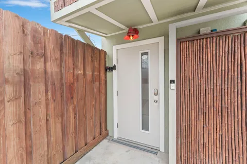 a balcony with furniture and wooden floor