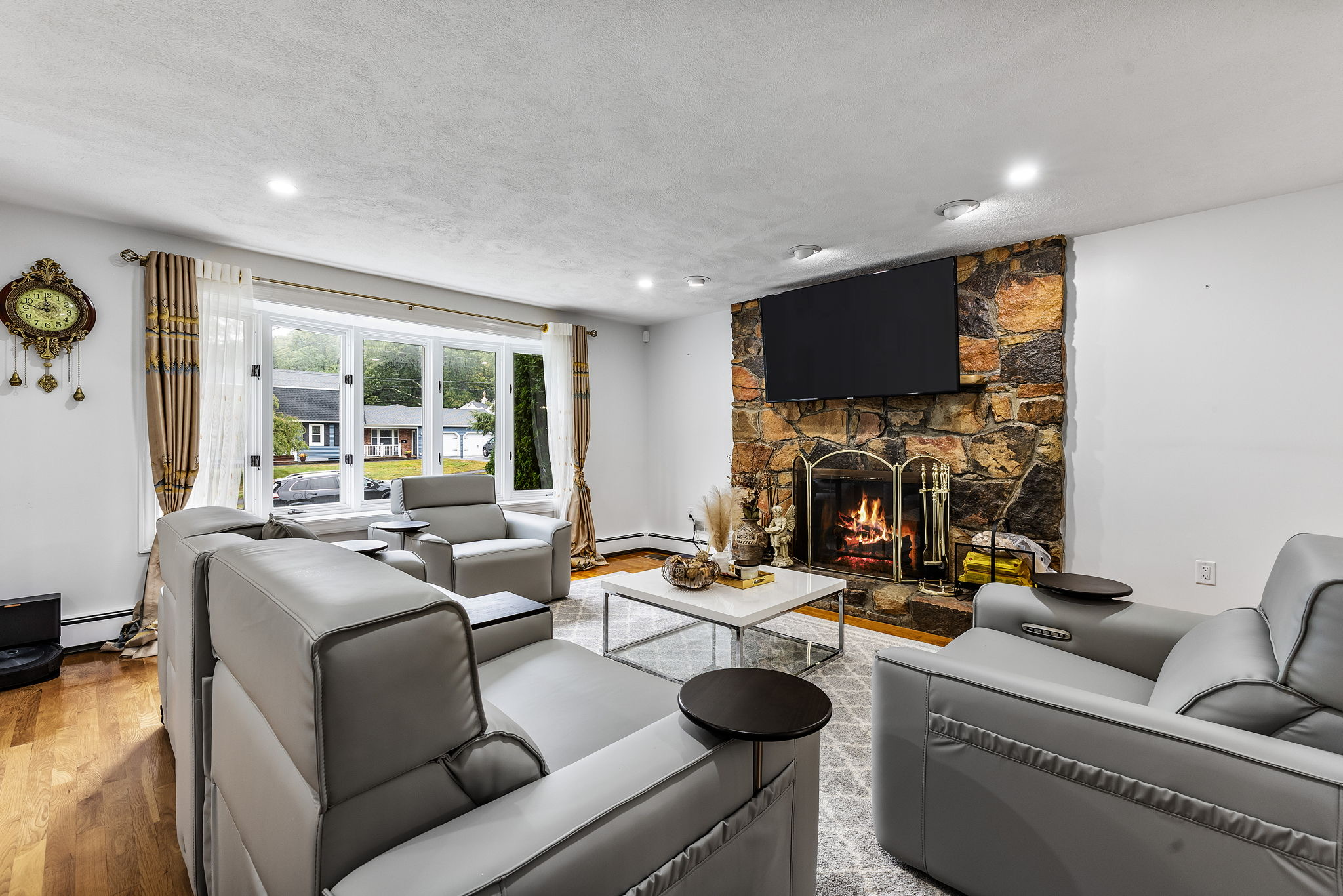 11 Ardmore Drive Danvers, MA 01923 - Photo 15 of 18 a living room with furniture a fireplace and a flat screen tv