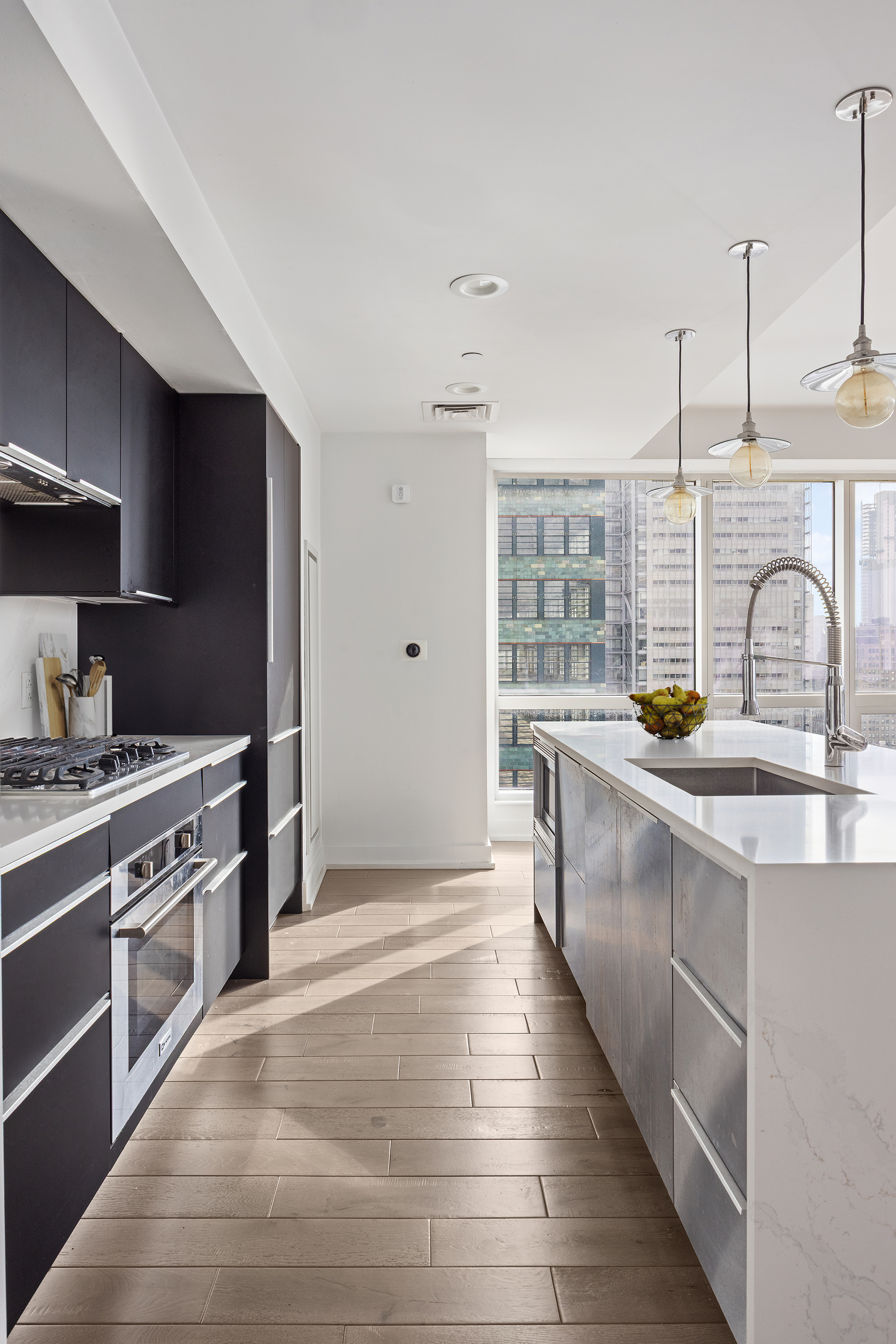 350 West 42nd Street, Unit 37G Manhattan, NY 10036 - Photo 7 of 14 a kitchen with stainless steel appliances granite countertop a sink stove and refrigerator