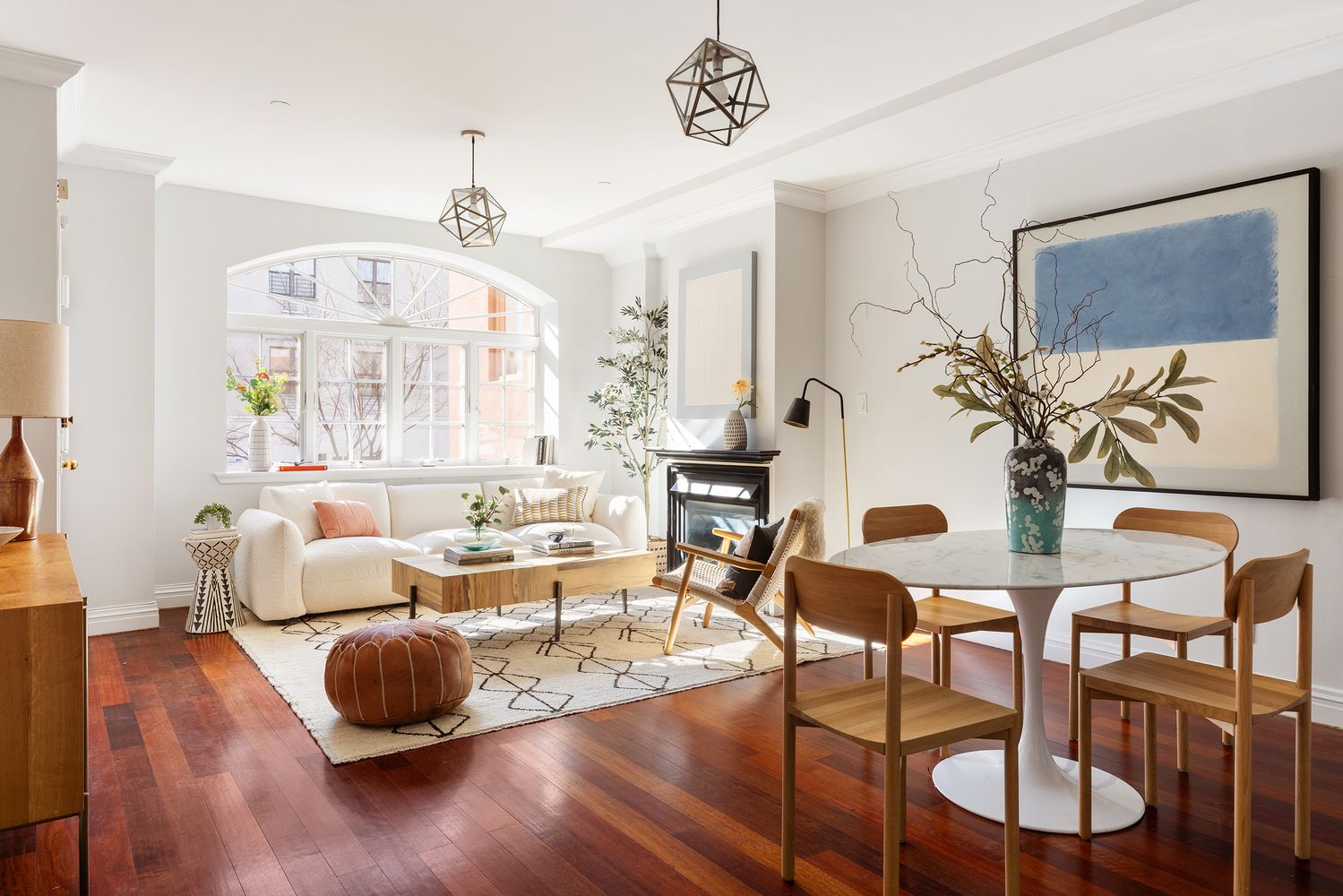 a living room with furniture dining table and a chandelier