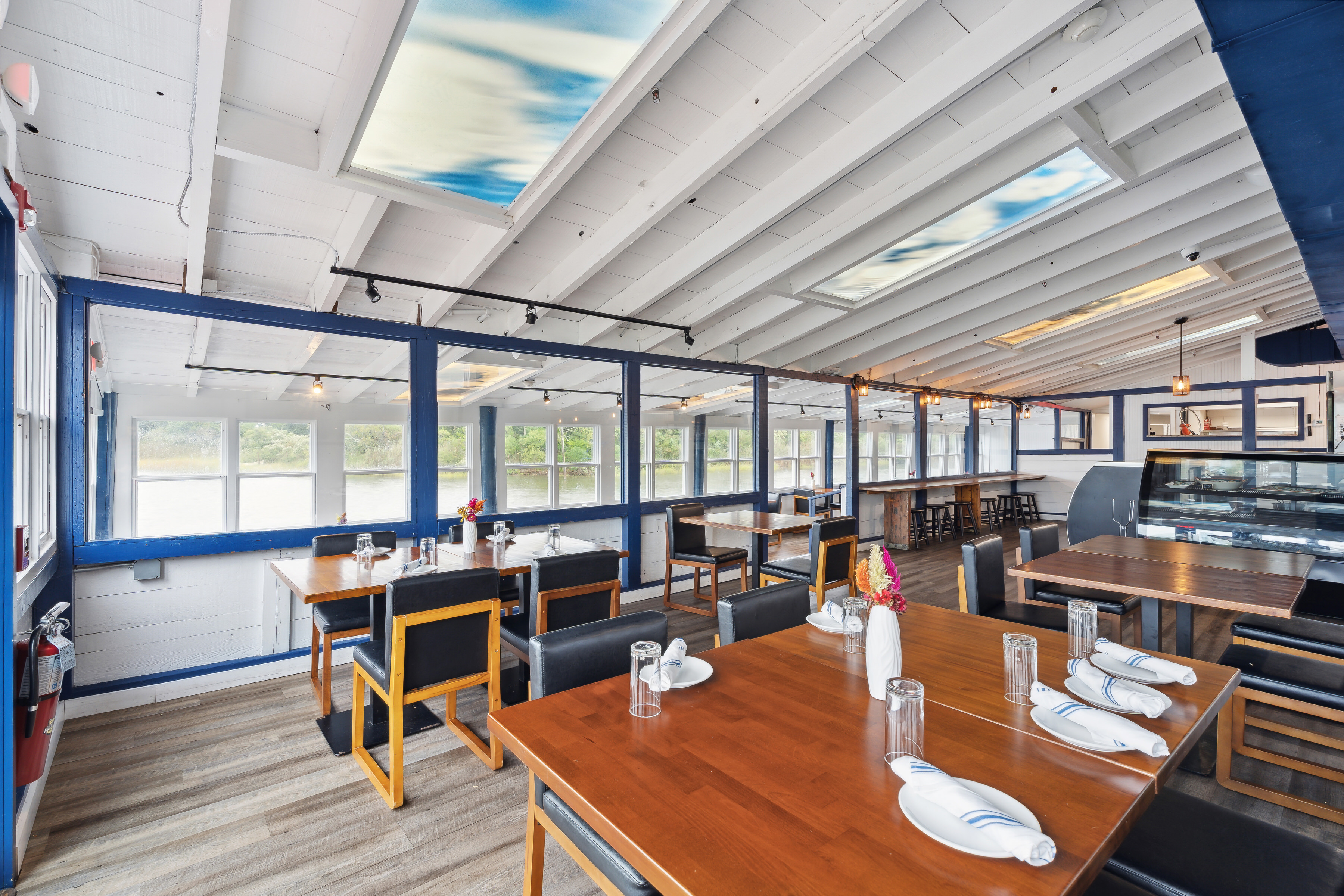5 Inlet Road Hampton Bays, NY 11946 - Photo 10 of 20 a living room with lots of furniture wooden floor and a table