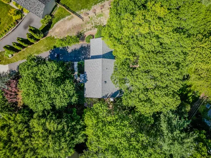 an aerial view of a house with a yard