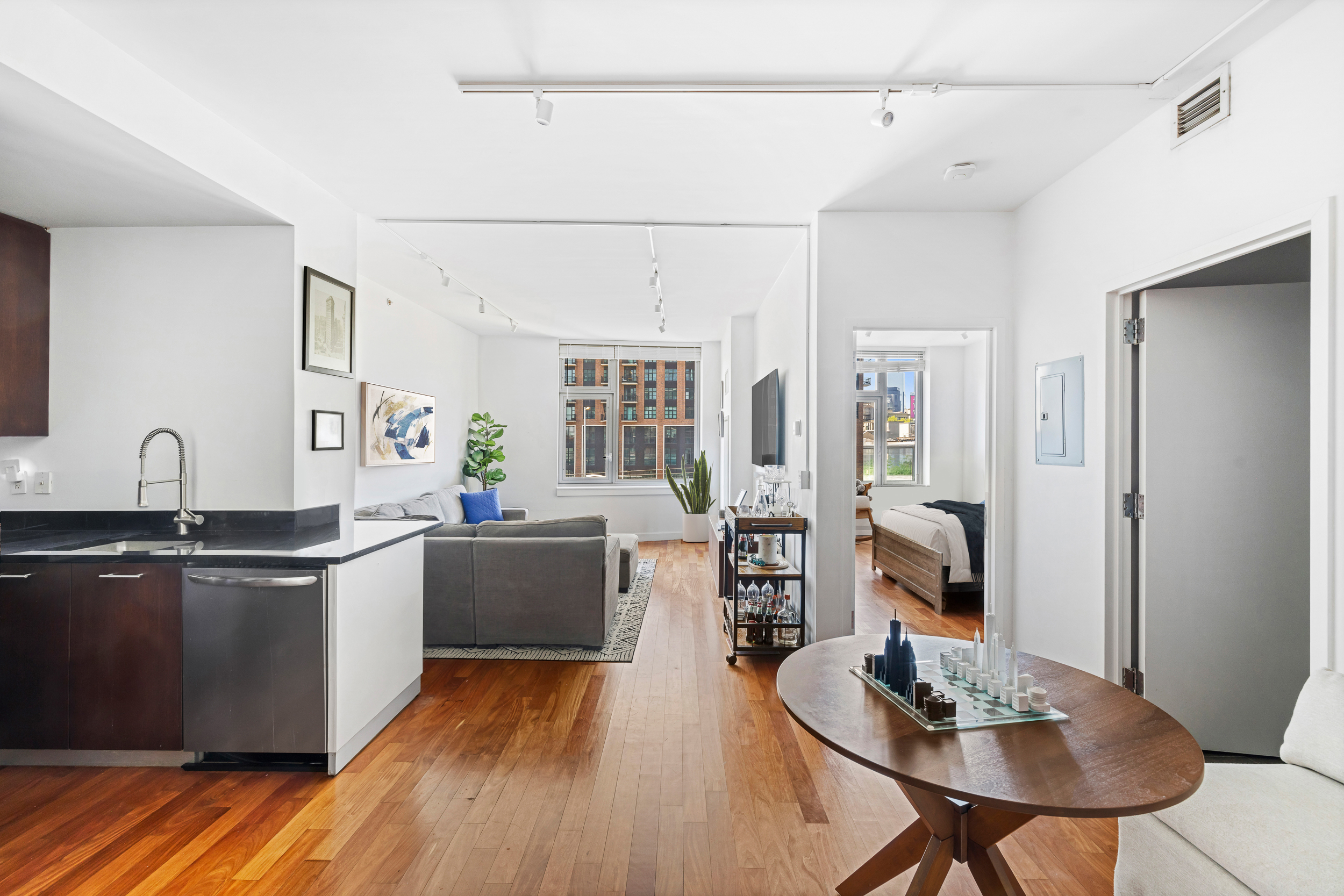 100 Jay Street, Unit 12K Brooklyn, NY 11201 - Photo 1 of 14 a kitchen with stainless steel appliances granite countertop a sink dishwasher and a stove with wooden floor