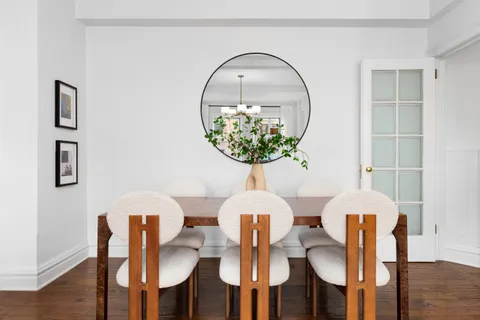 a table with chairs and painting on the table