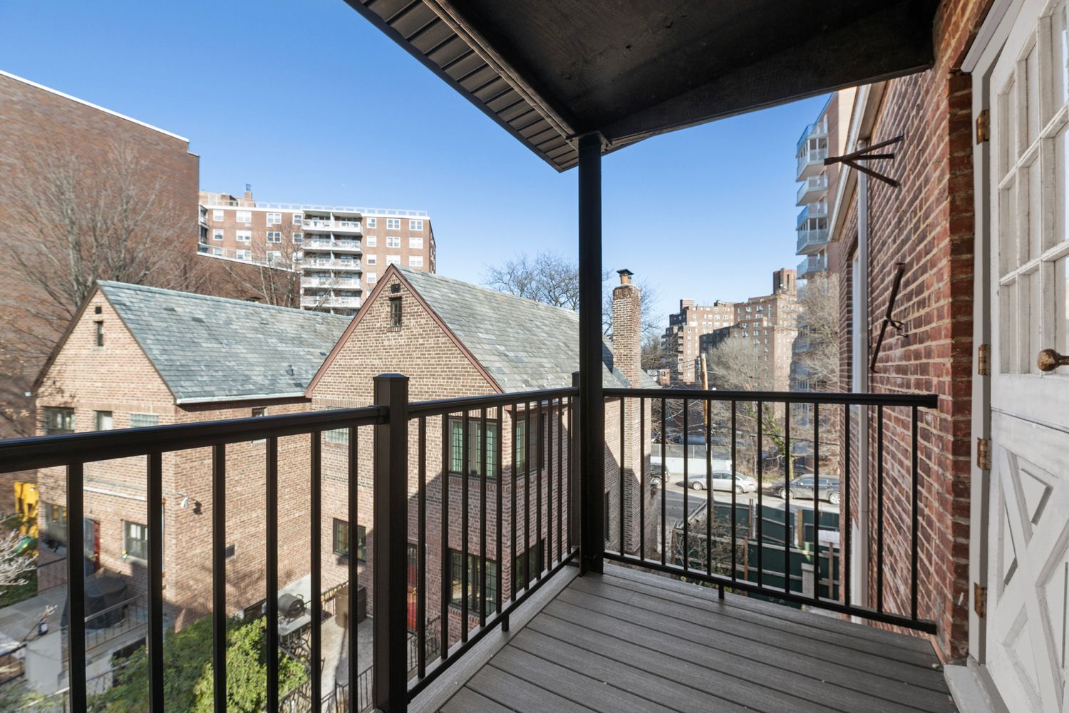 a view of balcony with wooden floor and fence
