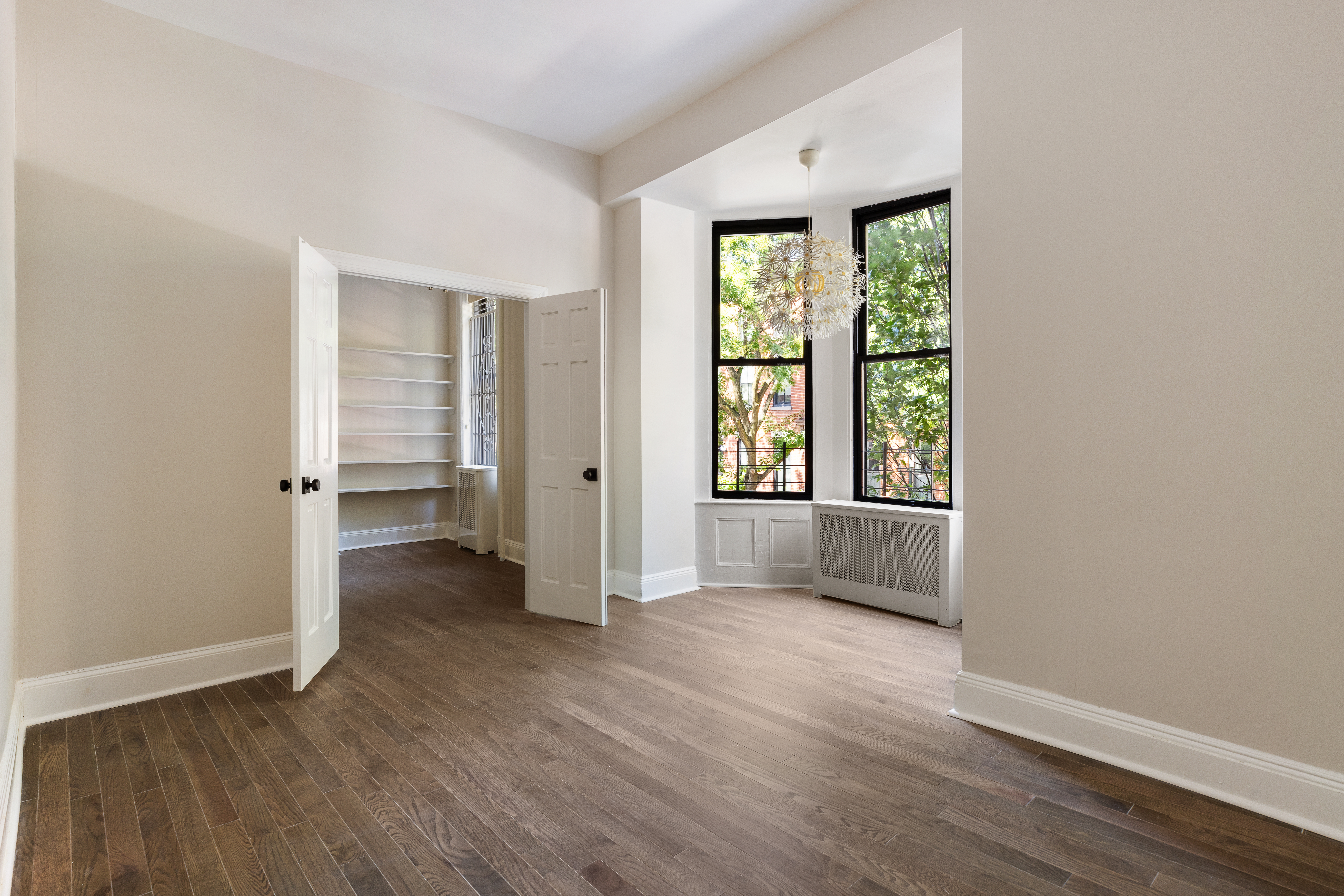 280 Clinton Street, Unit 1 Brooklyn, NY 11201 - Photo 7 of 11 an empty room with wooden floor and windows