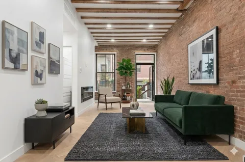 a living room with furniture and a potted plant