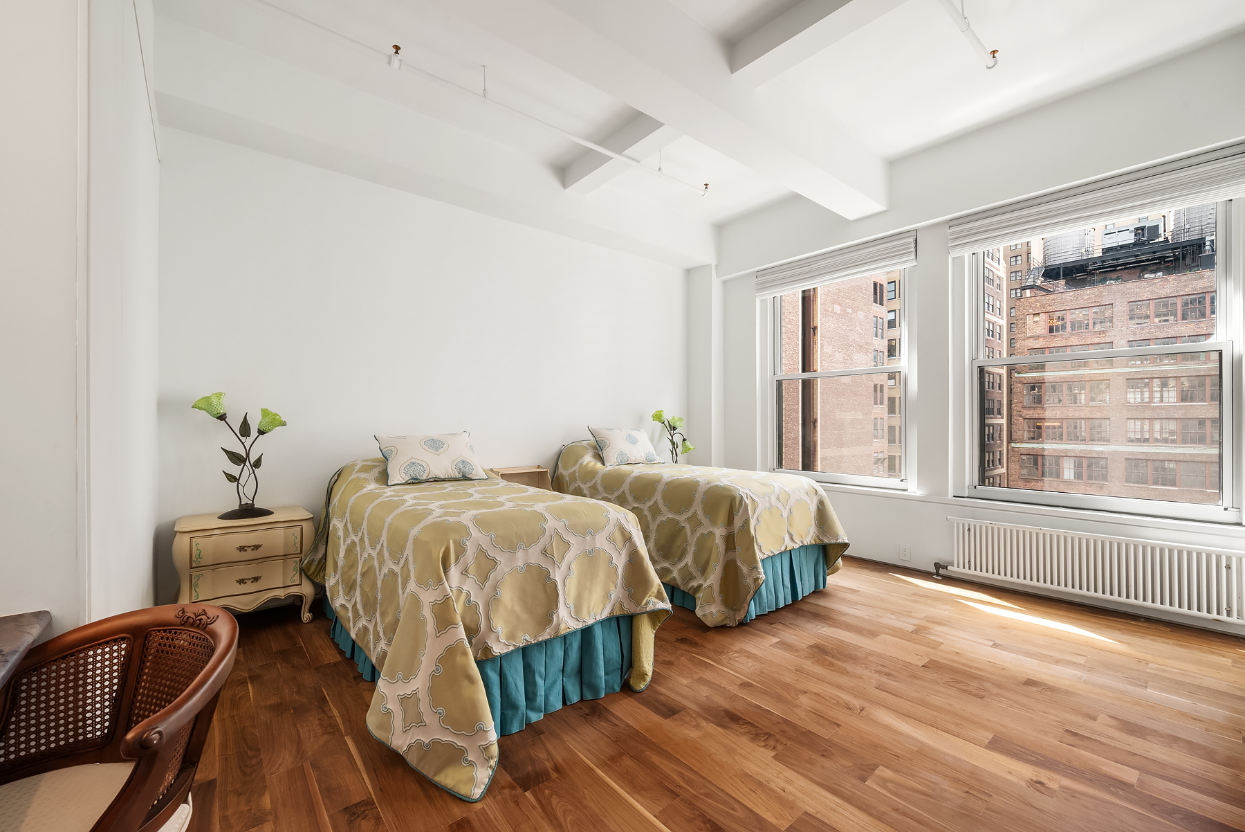 315 West 36th Street, Unit 11D Manhattan, NY 10018 - Photo 3 of 10 a spacious bedroom with two beds and a large window