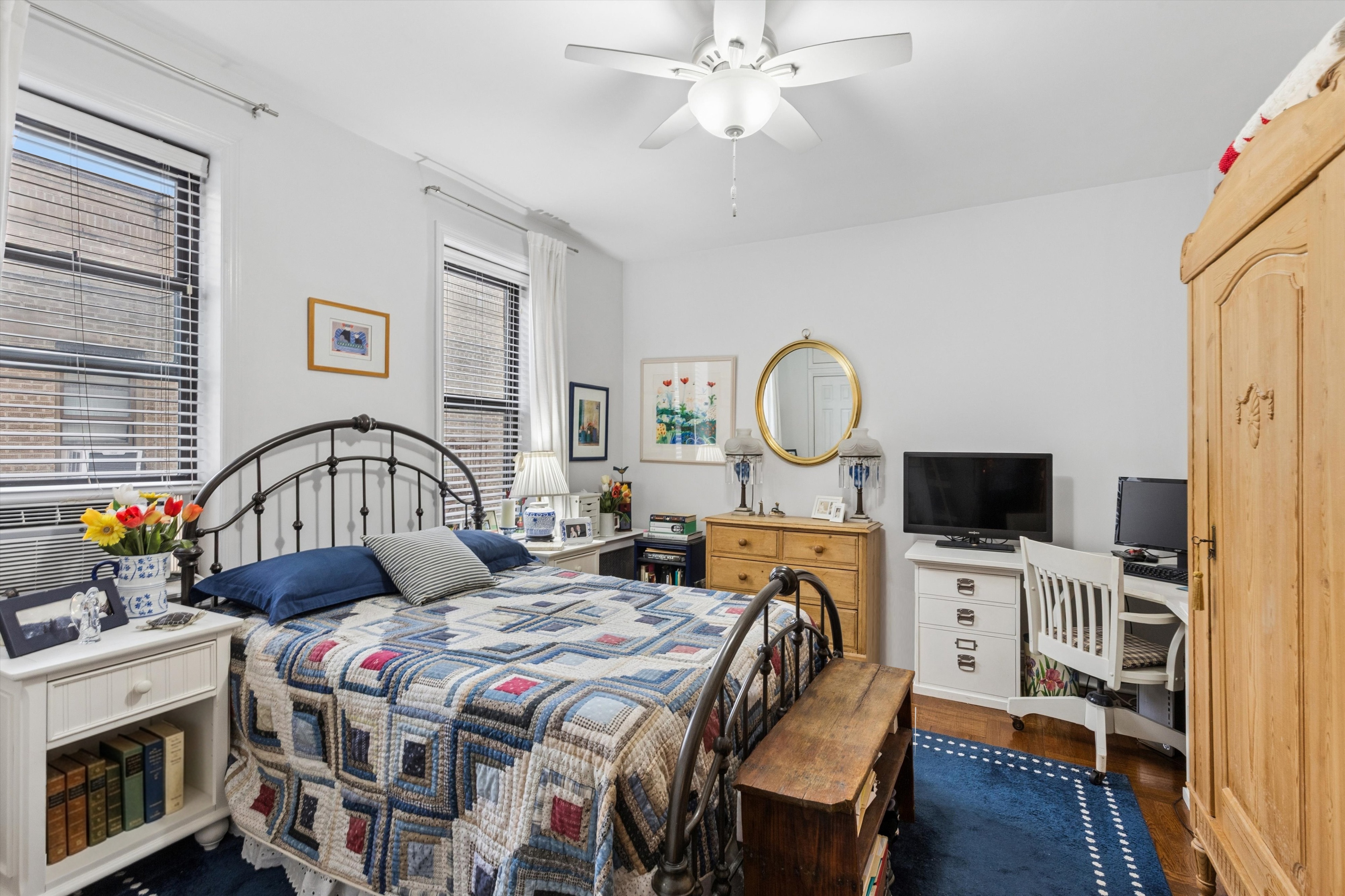 24 Bennett Avenue, Unit 62A Manhattan, NY 10033 - Photo 7 of 14 a bedroom with a bed a flat screen tv and dresser