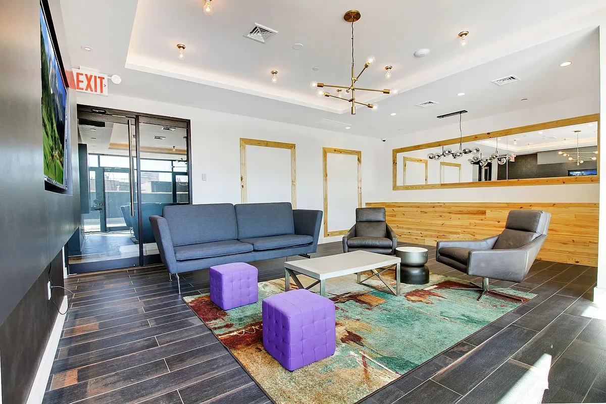 a living room with fireplace furniture and a rug