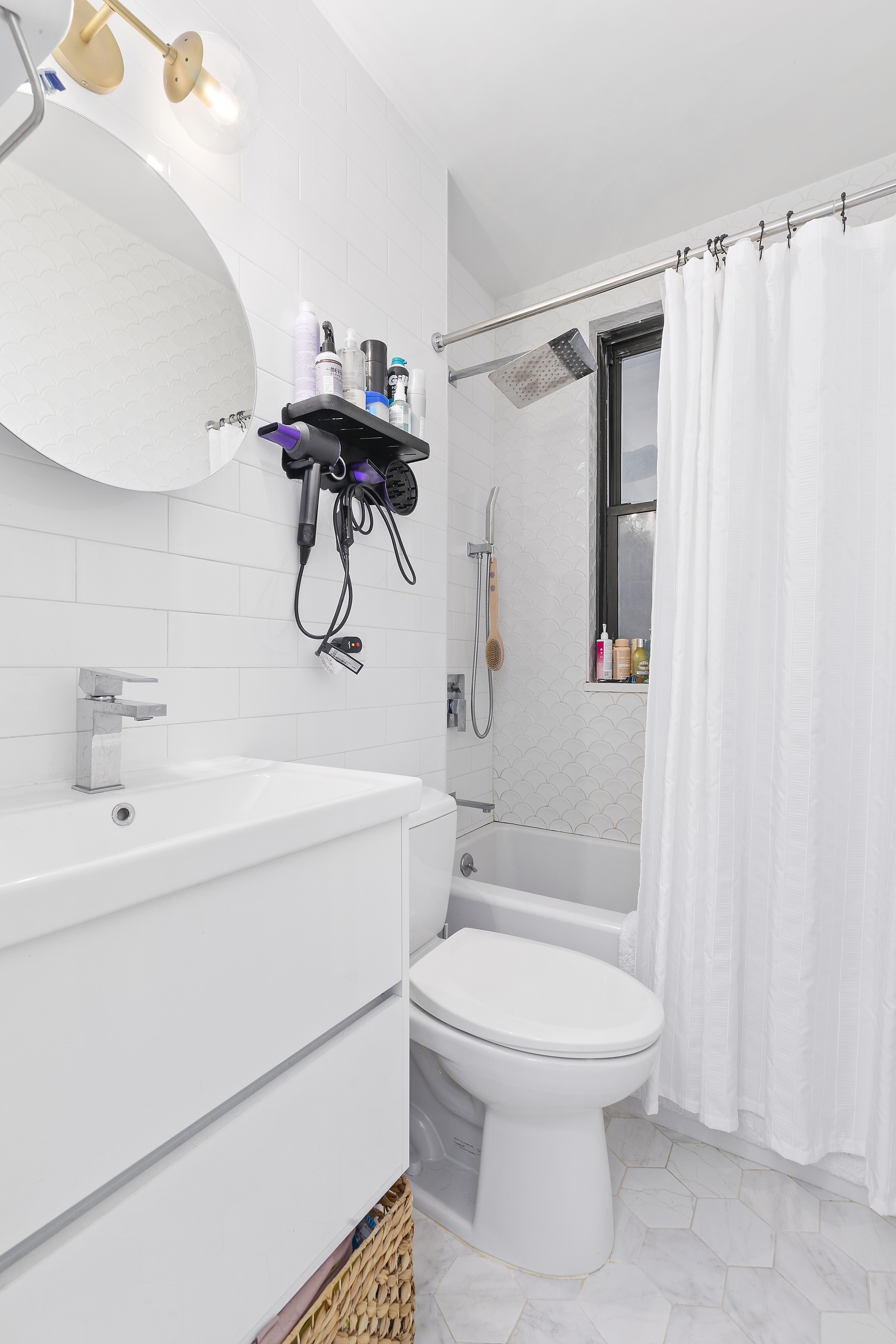 162 West 56th Street, Unit 602 Manhattan, NY 10019 - Photo 5 of 7 a bathroom with a shower a toilet and a sink