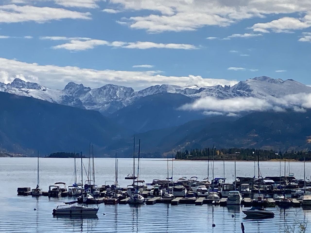 a roof deck with table and chairs a barbeque with wooden fence