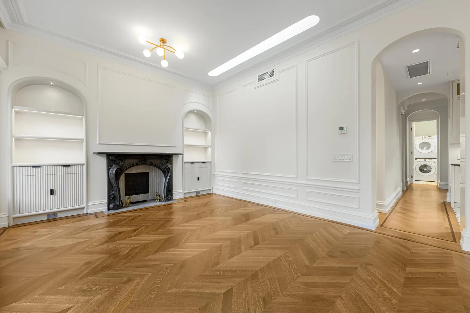 a view of empty room with cabinet and a fireplace