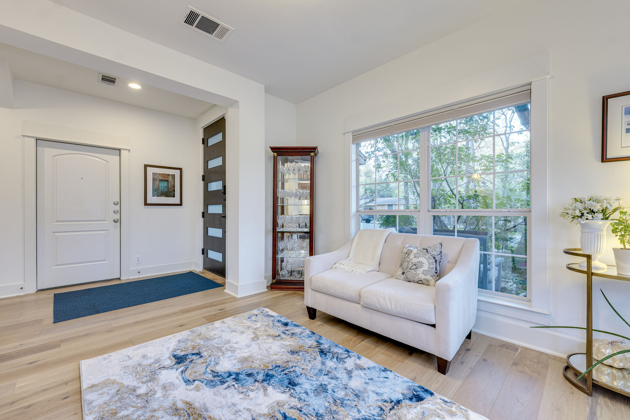 109 West Spring Drive Austin, TX 78746 - Photo 8 of 22 a living room with furniture and a large window