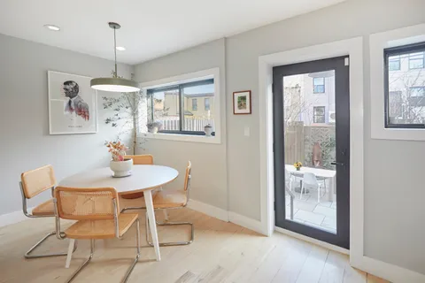 a view of a dining room with furniture window and wooden floor