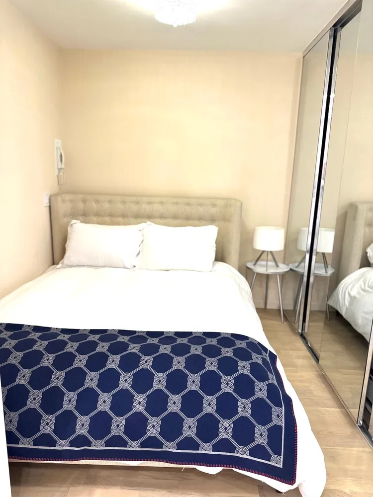 a bedroom with a large bed and a mirror