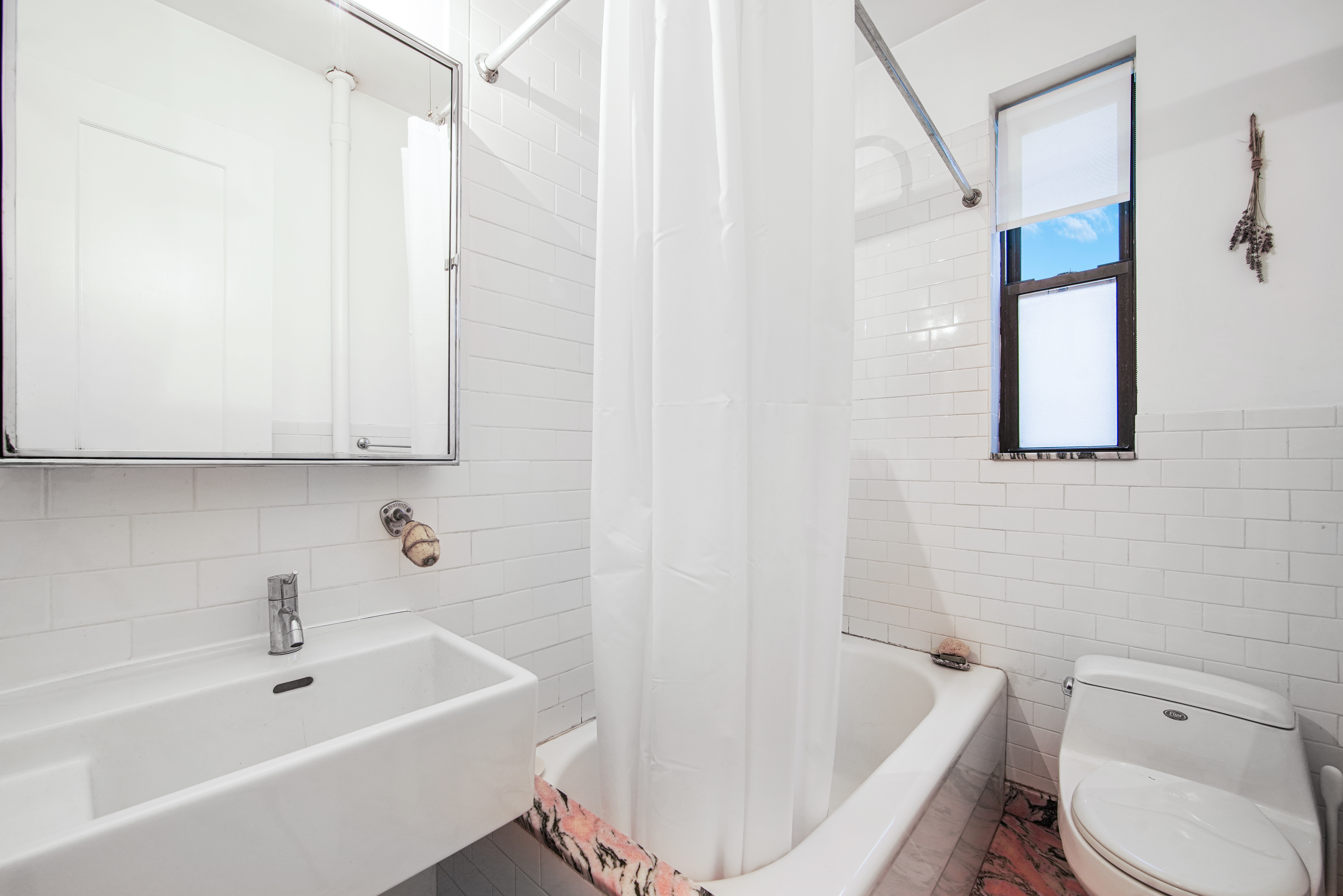 67 Morton Street, Unit 2B Manhattan, NY 10014 - Photo 8 of 12 a bathroom with a bathtub a toilet a sink and a shower