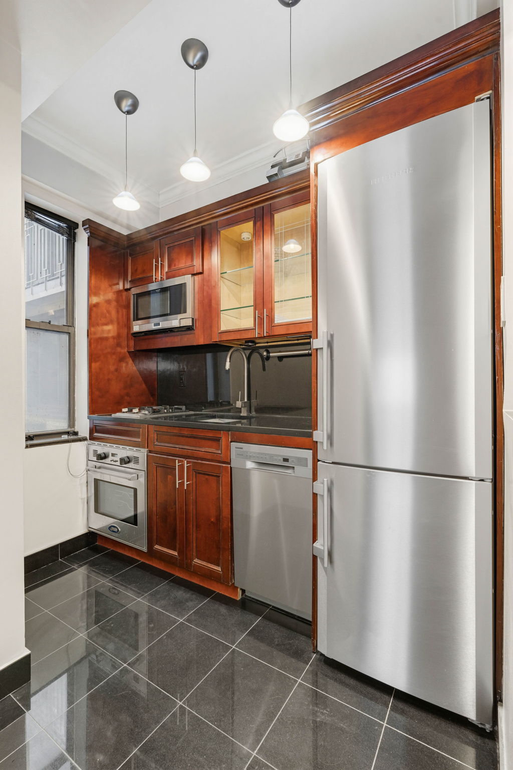 230 Central Park South, Unit 8F Manhattan, NY 10019 - Photo 5 of 7 a kitchen with stainless steel appliances granite countertop a refrigerator a oven a sink and white cabinets