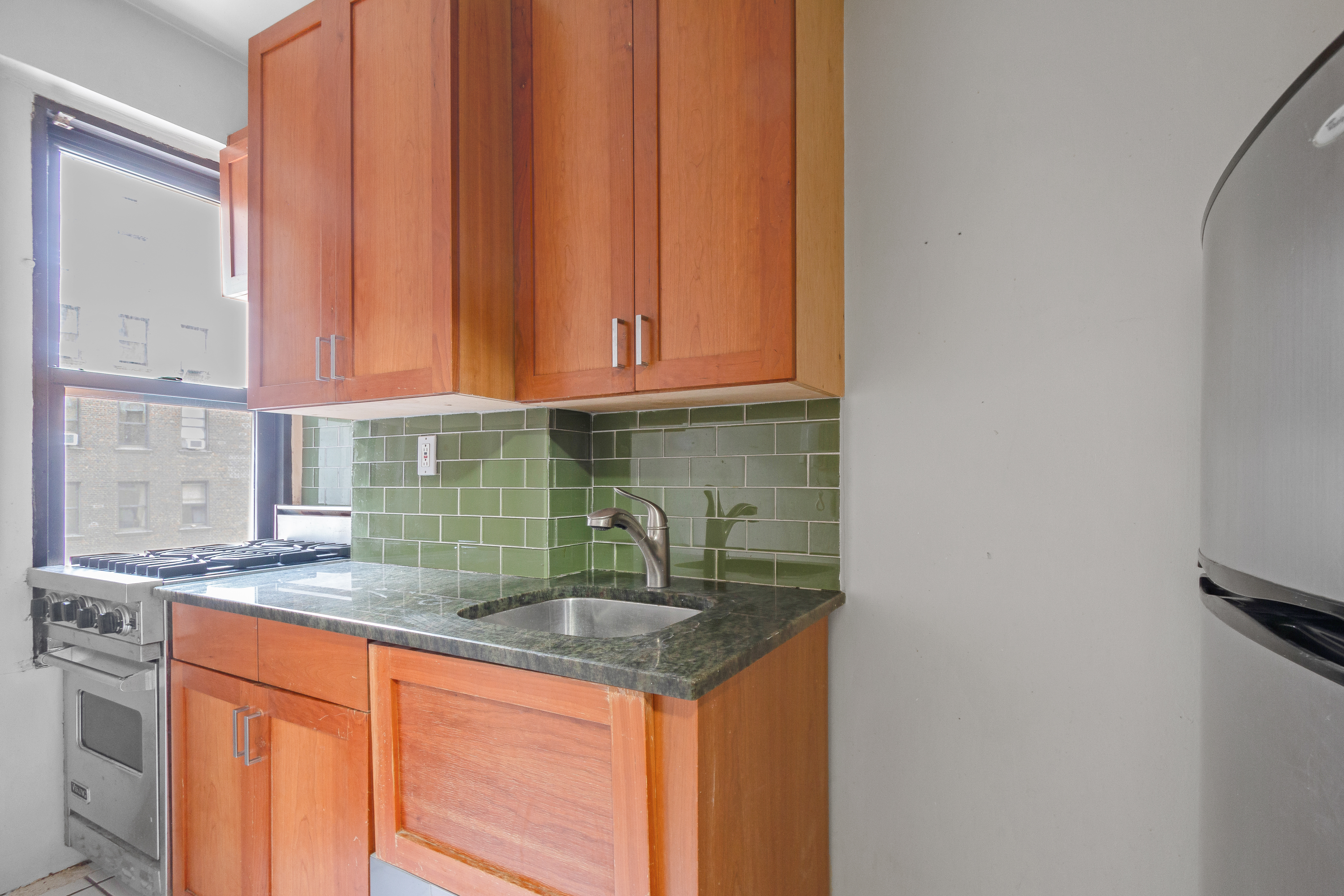 235 West End Avenue, Unit 8G Manhattan, NY 10023 - Photo 7 of 13 a kitchen with stainless steel appliances granite countertop a sink stove and cabinets