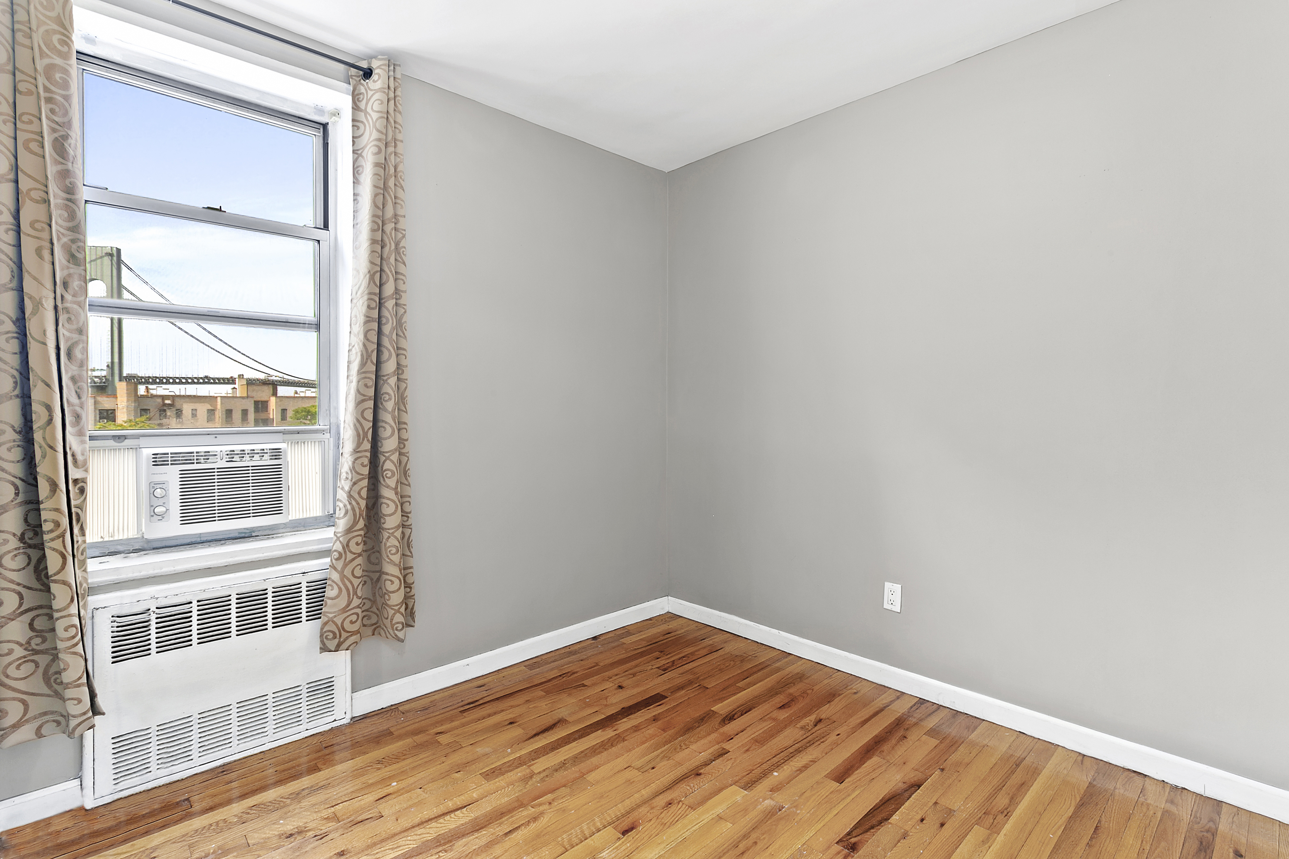 9602 4th Avenue, Unit 6D Brooklyn, NY 11209 - Photo 4 of 7 a view of empty room with wooden floor and fan