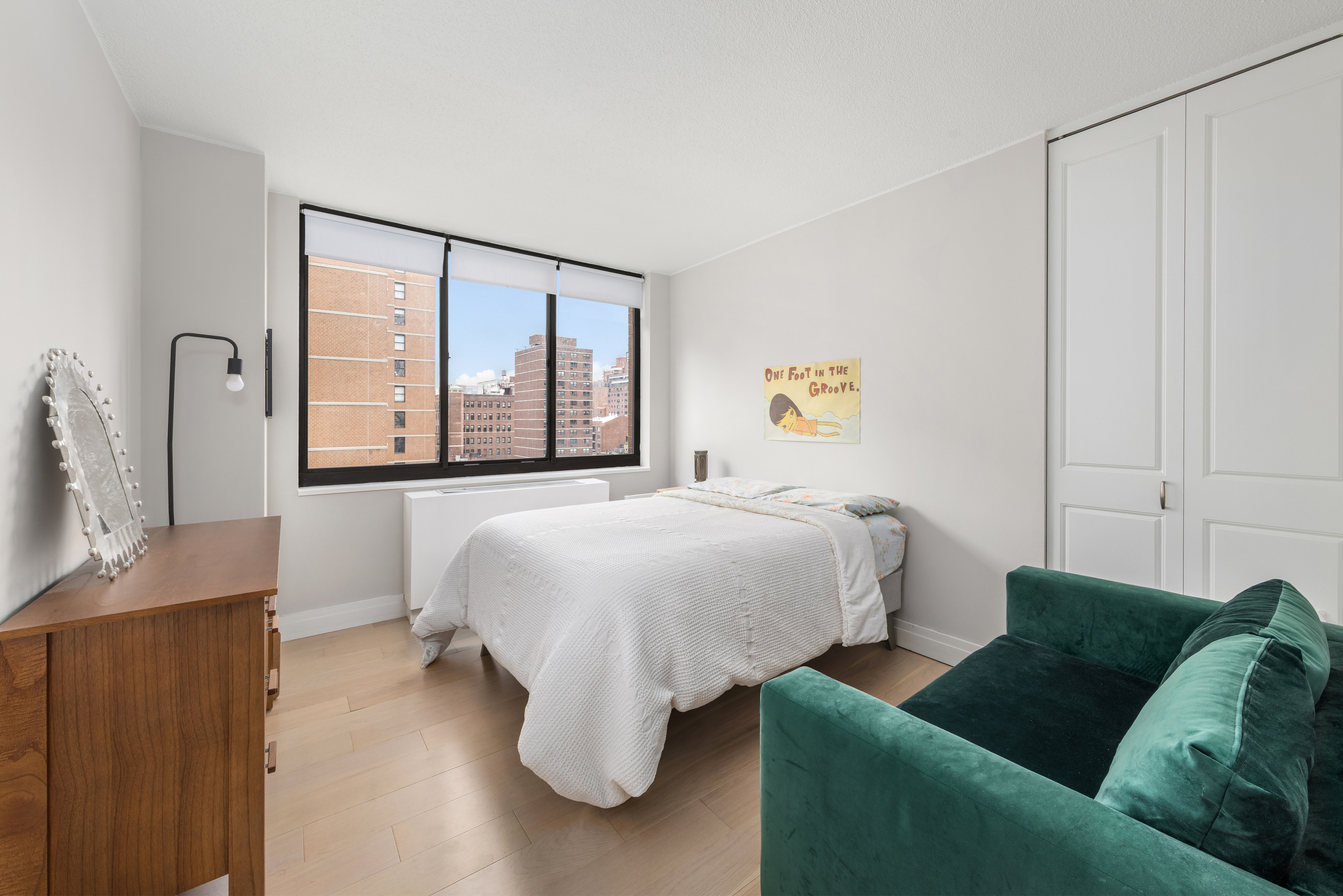 151-155 East 31st Street, Unit 12C Manhattan, NY 10016 - Photo 4 of 7 a bedroom with a bed couch and window