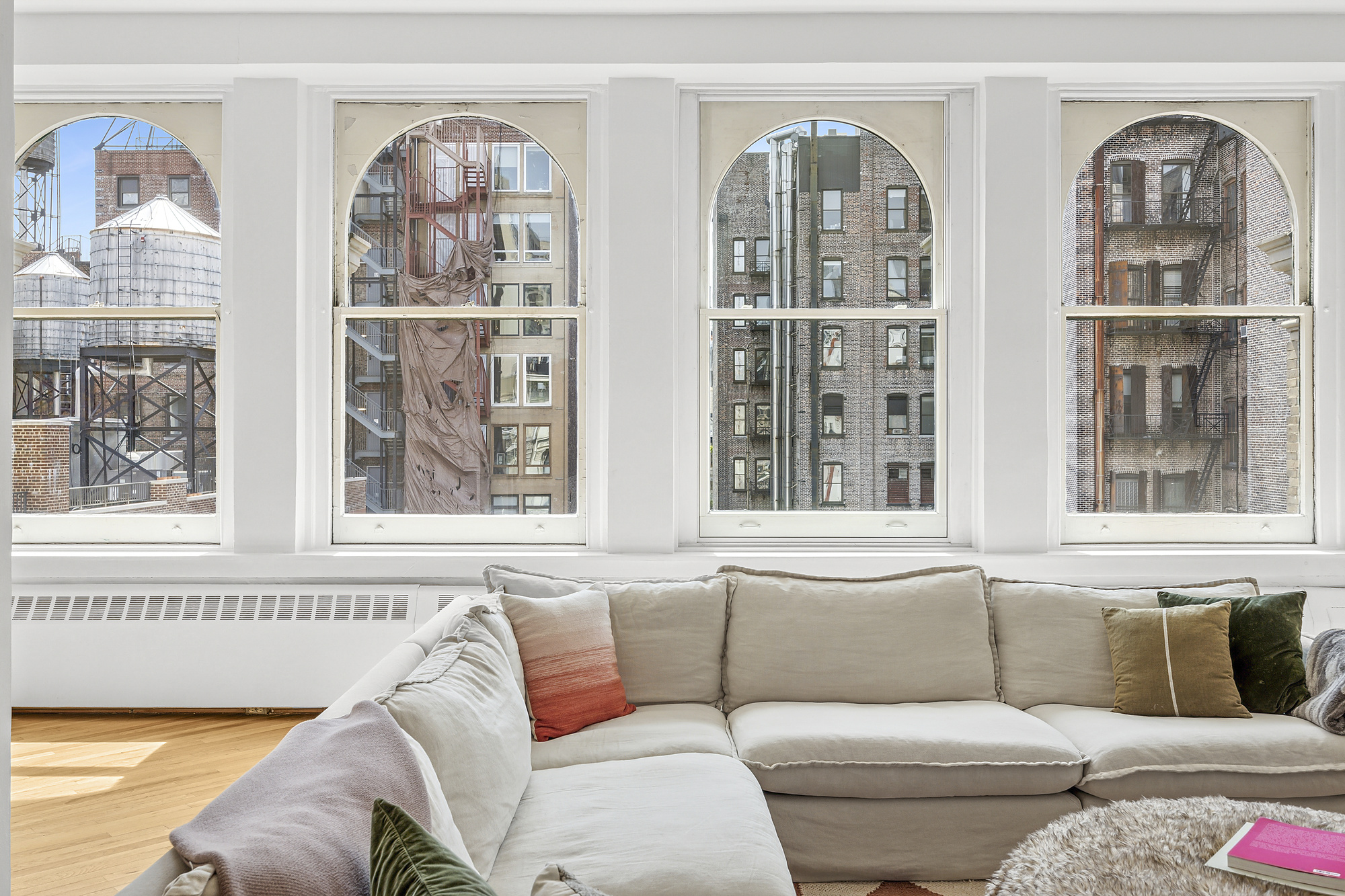 35 East 12th Street, Unit 8C Manhattan, NY 10003 - Photo 2 of 22 a living room with furniture and large windows
