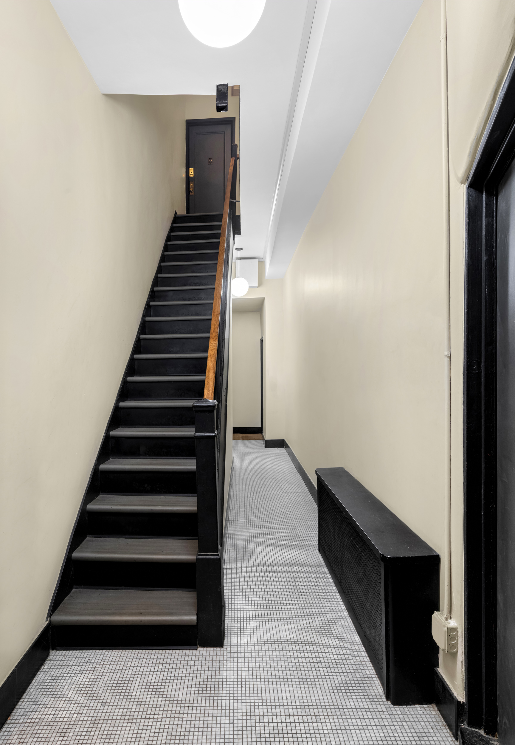 141 Sullivan Street, Unit G4 Manhattan, NY 10012 - Photo 5 of 6 a view of entryway and hall with wooden floor