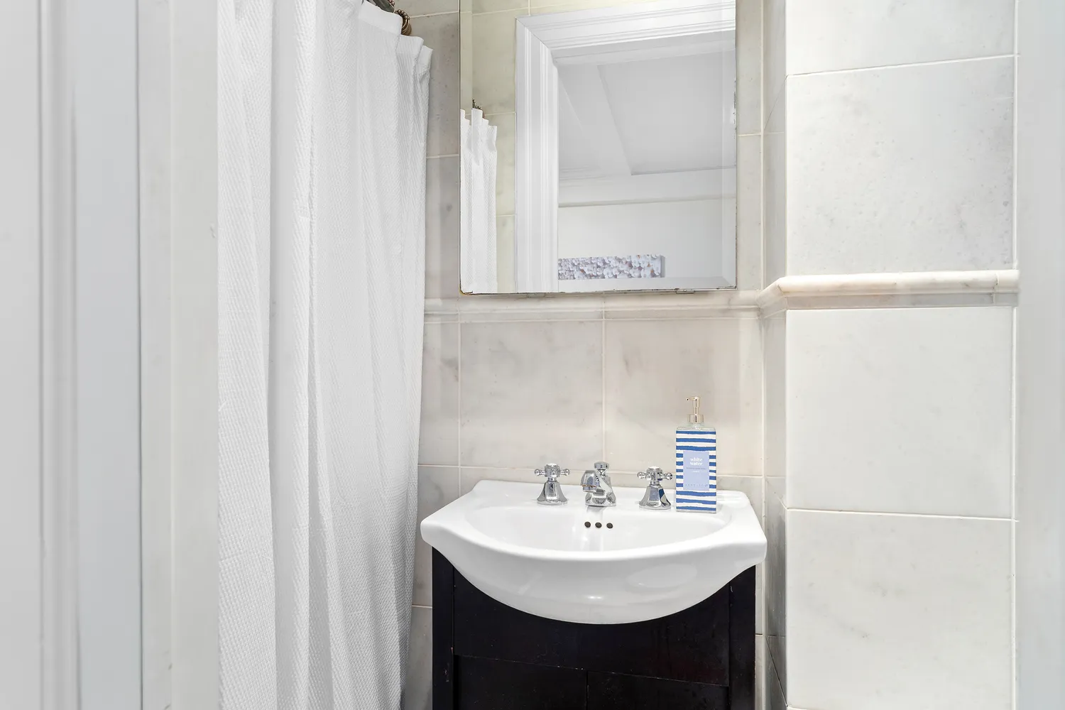 a bathroom with a sink a mirror and a shower