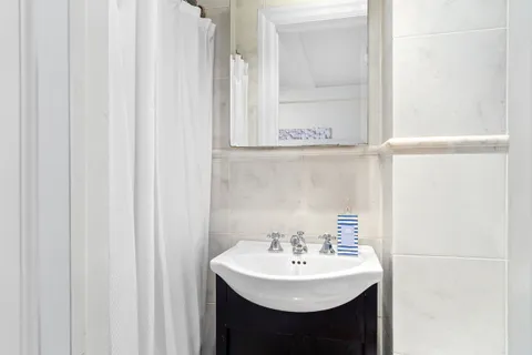 a bathroom with a sink a mirror and a shower