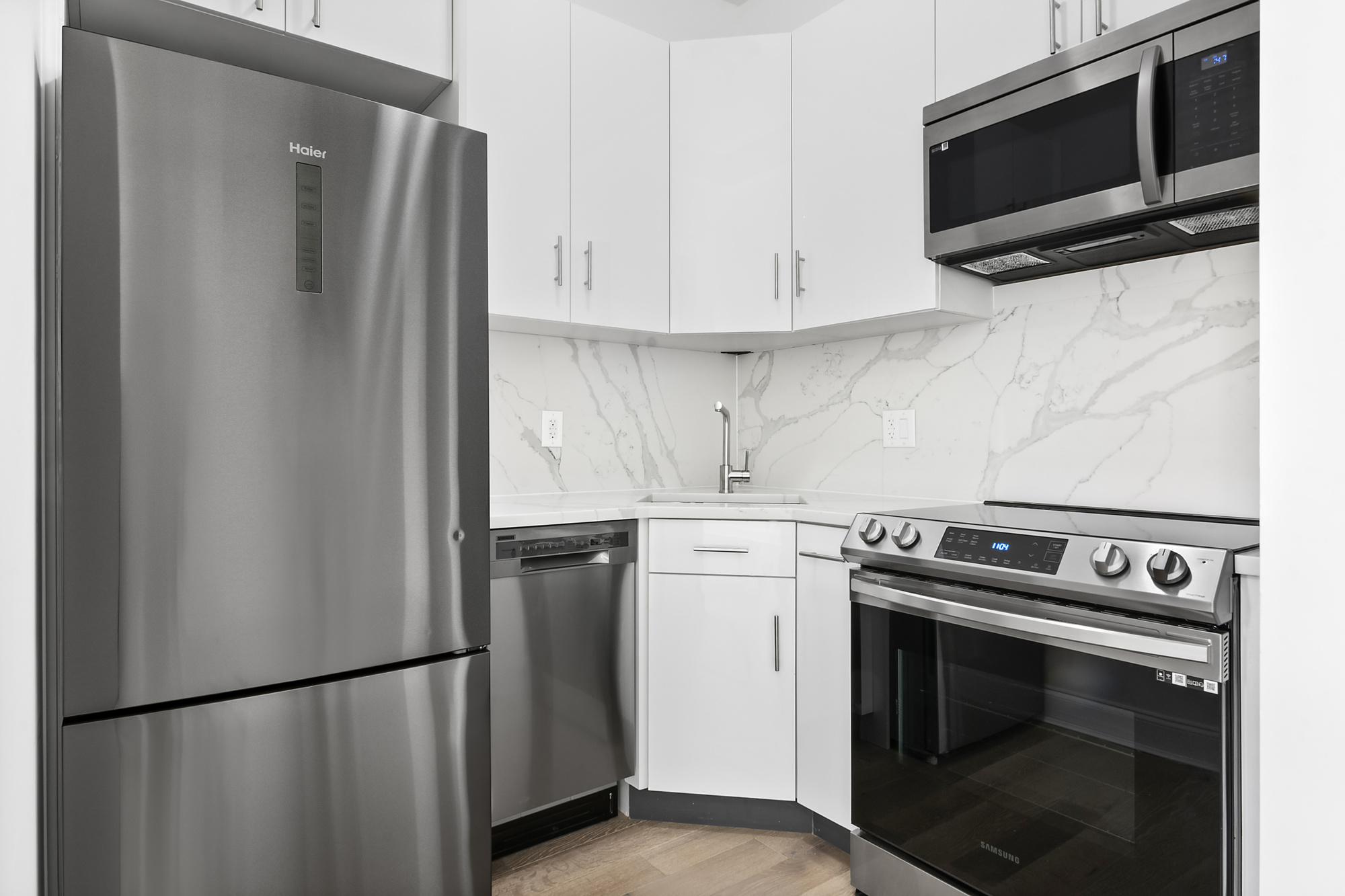 467 Tompkins Avenue, Unit 3A Brooklyn, NY 11216 - Photo 4 of 12 a kitchen with stainless steel appliances a refrigerator stove and microwave