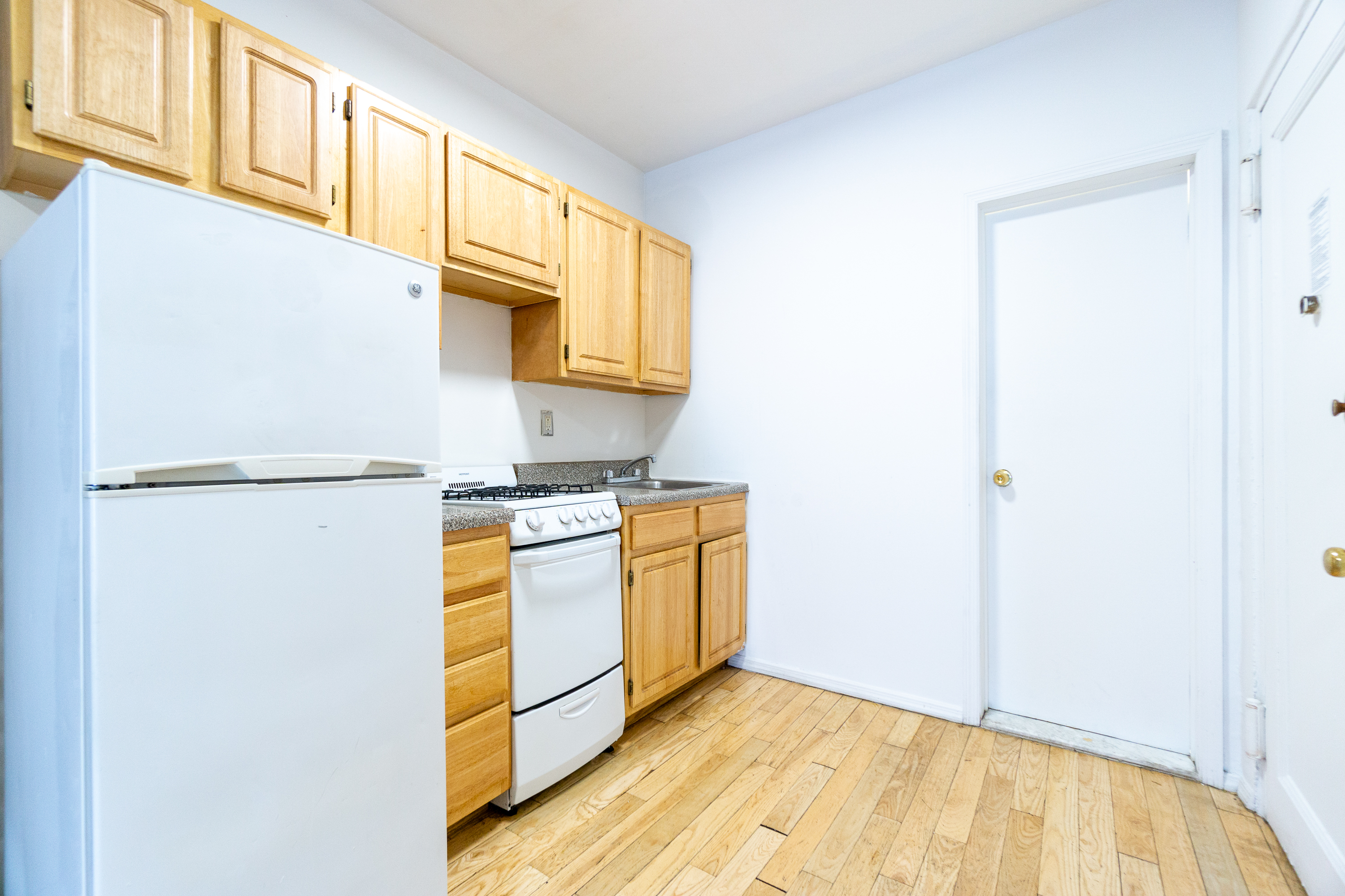 339 East 6th Street, Unit 12 Manhattan, NY 10003 - Photo 5 of 12 a kitchen with stainless steel appliances a refrigerator and a stove