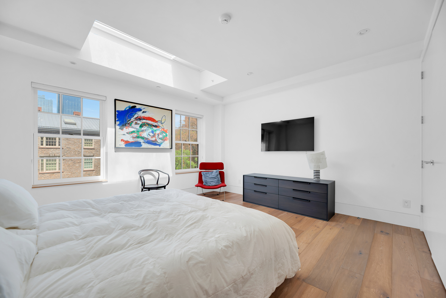 440 West 20th Street Manhattan, NY 10011 - Photo 7 of 20 a bedroom with a bed and a flat screen tv