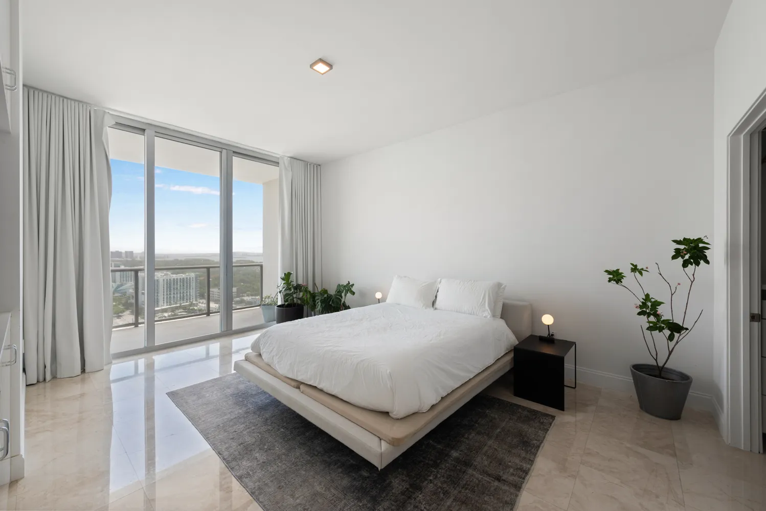 a bedroom with a bed lamp and window