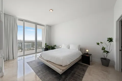 a bedroom with a bed lamp and window