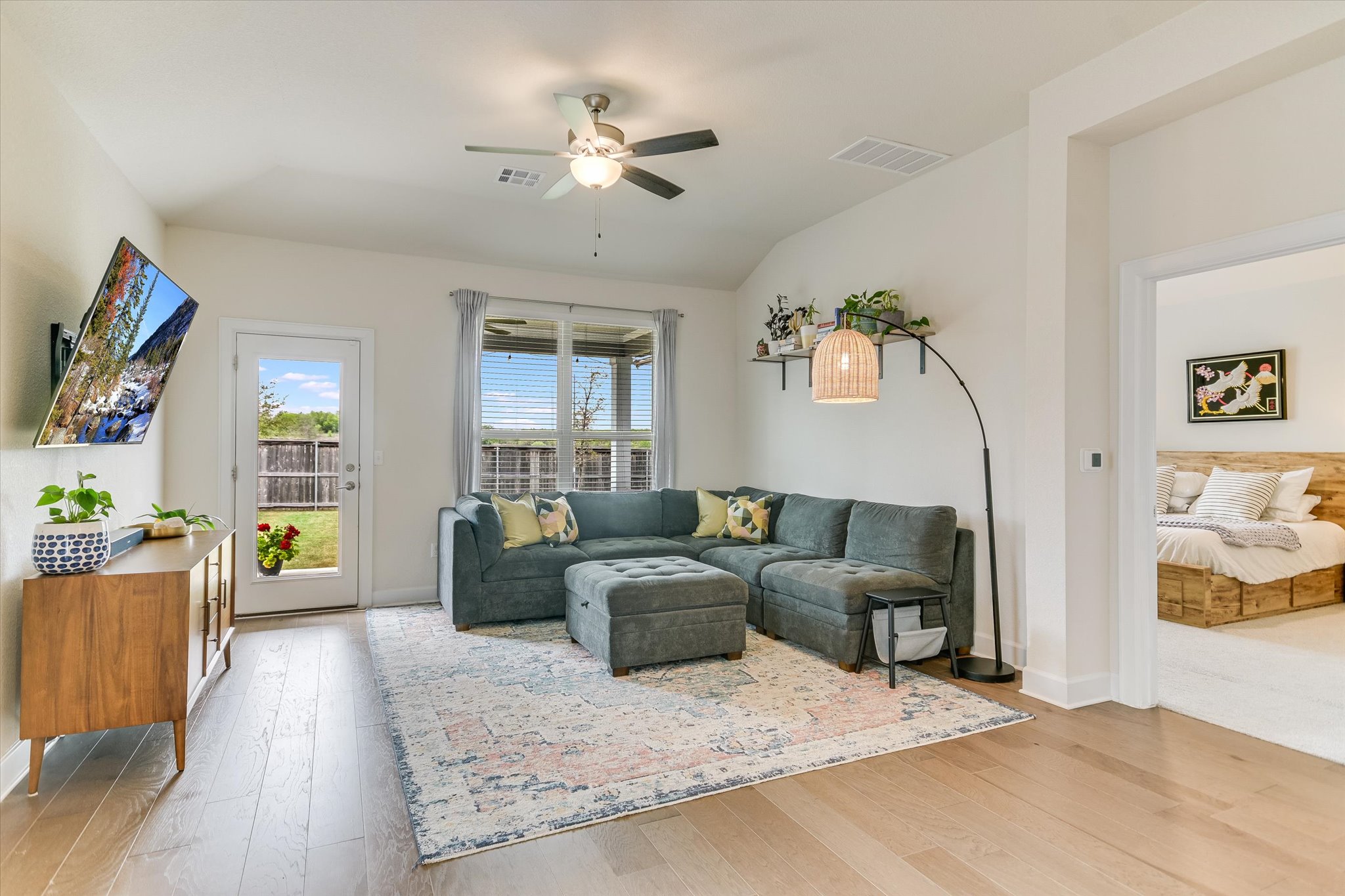a living room with furniture and a wooden floor
